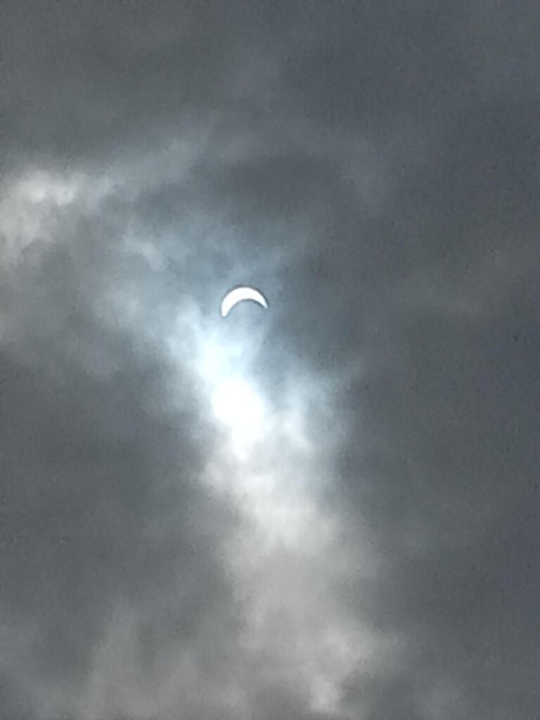 Photo of a partial eclipse through light cloud cover