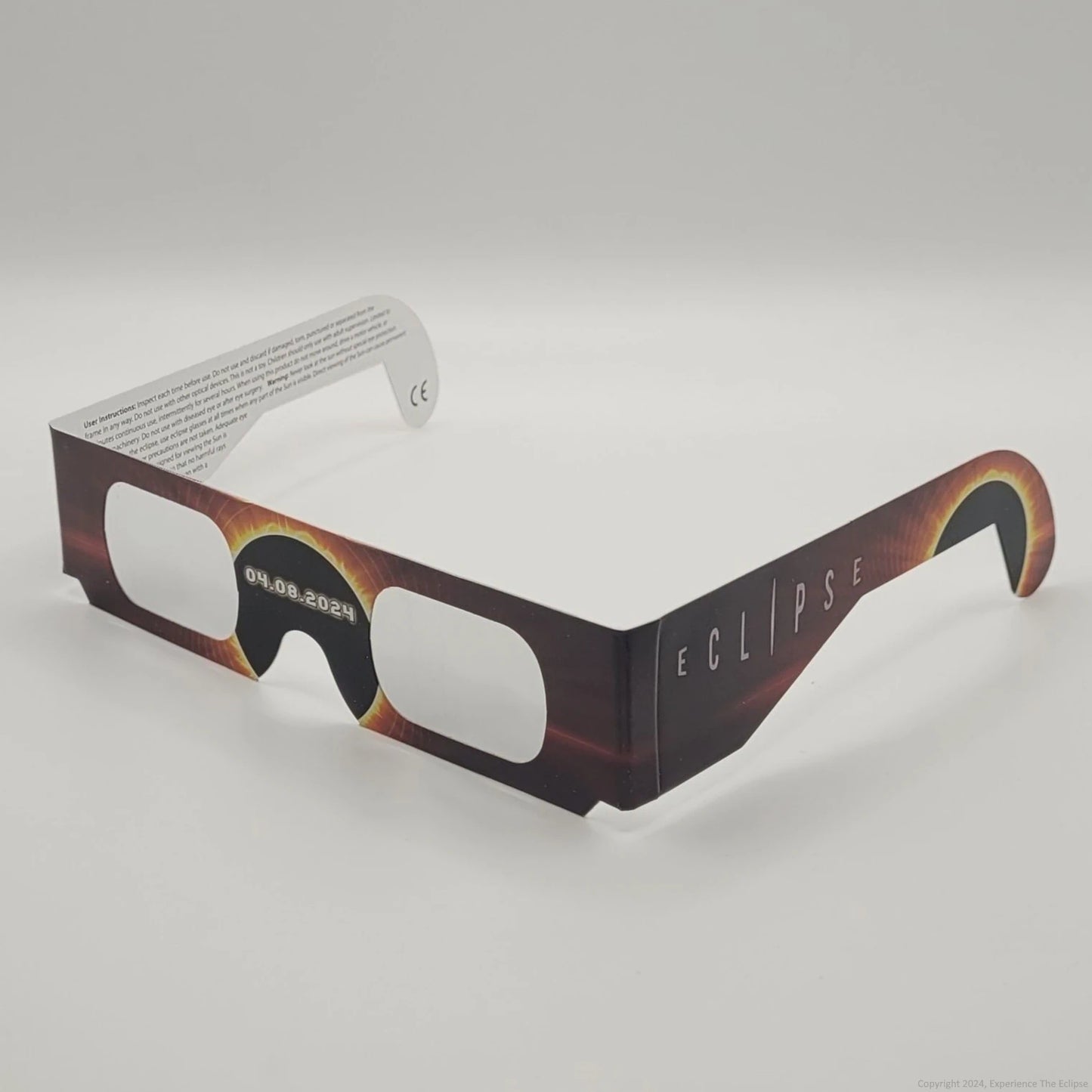 A single pair of orange solar eclipse glasses.